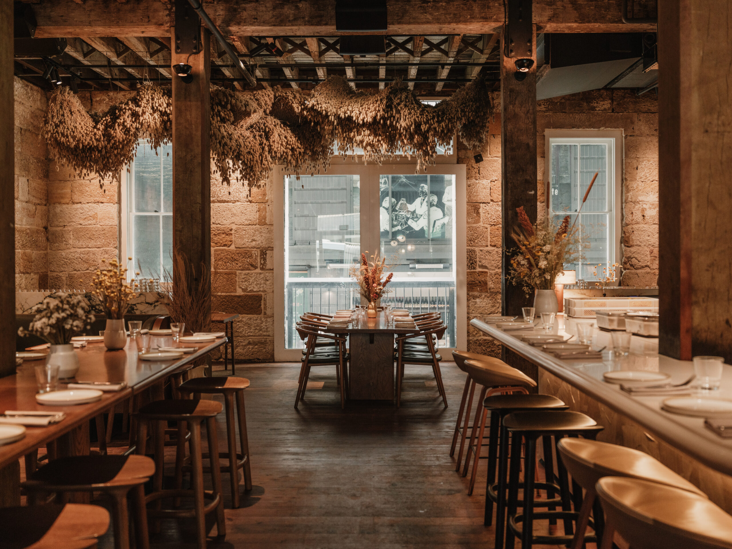Grana dining room with sandstone walls and set tables
